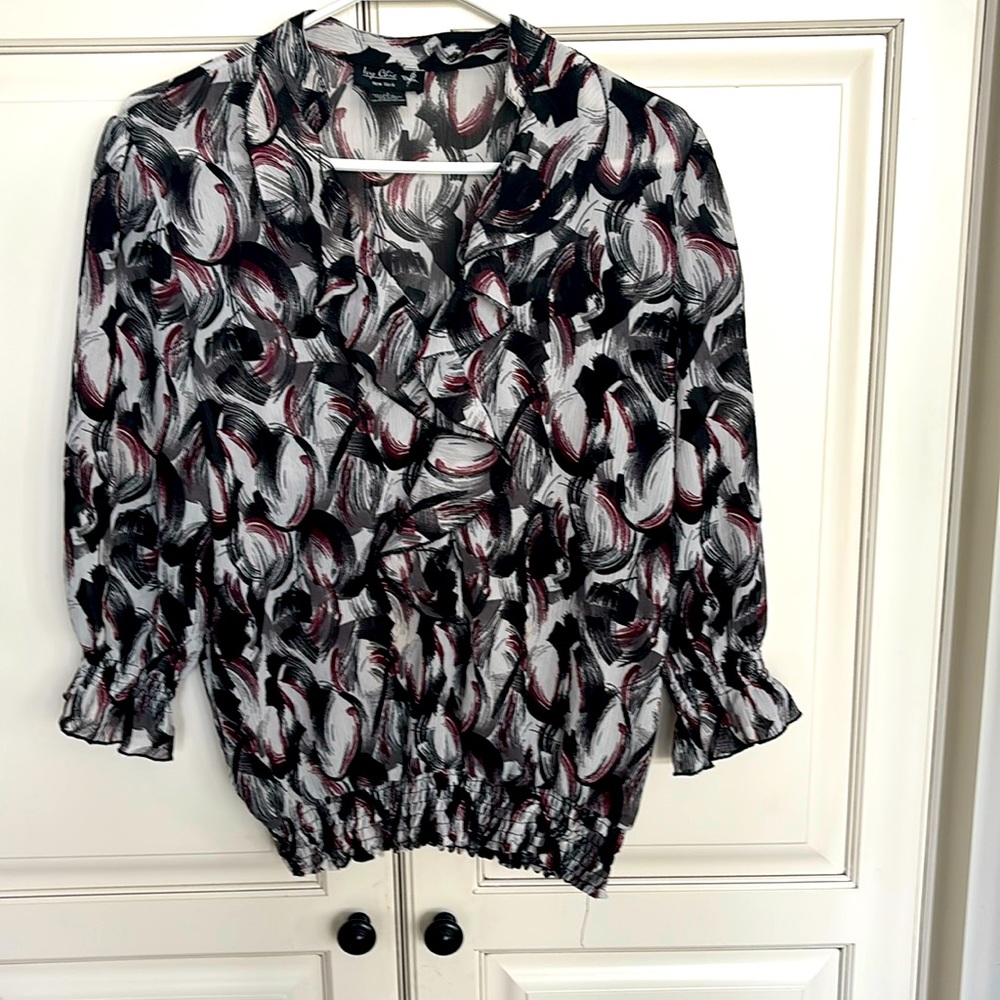 Sheer patterned blouse with ruffles and smocked sleeves and waist.  NWOT.  S